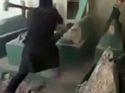 A video published in which an ISIS militant destroys the grave of Prophet Jonah