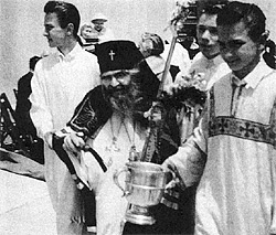 St. John sprinkling with holy water at his last Pascha in 1966. Pavel Lukianov is behind his left shoulder.