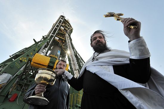 A Russian Orthodox priest blesses the Soyuz TMA-18 spacecraft at Baikonur Cosmodrome on April 1, 2010. (VYACHESLAV OSELEDKO/AFP/Getty Images)