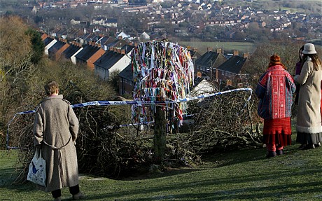 People gather around the vandalised Holy Thorn tree that was cut down overnight on Wearyall Hill. Photo: Getty.
