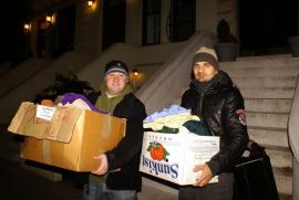 Seminarian Aaron Oliver (left) and alumnus Adrian Budiça deliver warm clothing to the poor outside of Penn Station (Photo: T. Hoff).