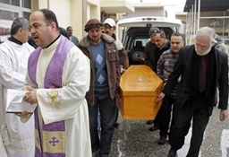 Mourners carry the coffin of slain Christian Fawzi Rahim, 76, during his funeral Mass at St. George Chaldean Church in Baghdad, Iraq, Friday, Dec. 31, 2010.
