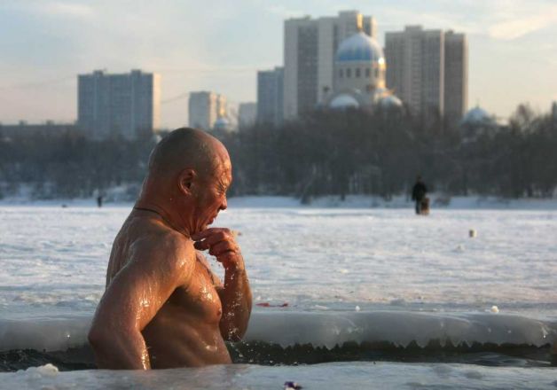 A Russian Orthodox believer plunges himself into icy waters. AFP PHOTO / ANDREI SMIRNOV (Photo credit should read ANDREI SMIRNOV/AFP/Getty Images) 