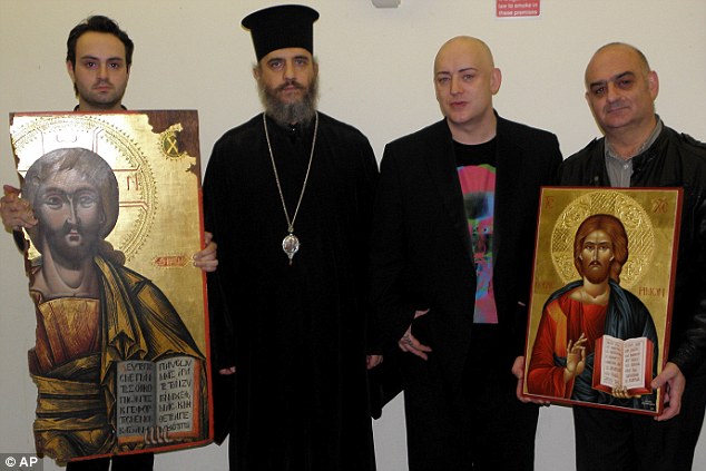 Boy George and composer John Themis with the token of gratitude given them by the Church of Cyprus after the return of the icon, held by an unnamed official with Bishop Porfyrios