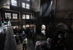 Christians look at the Saint Mary Church, which was set on fire during clashes between Muslims and Christians on Saturday in the heavily populated area of Imbaba in Cairo May 8, 2011. (Photo: Reuters / Mohamed Abd El-Ghany)