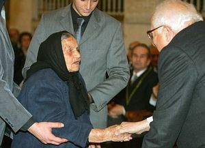 Academy of Athens president Panayiotis Vokotopoulos awards a prize to Vasiliki Lambidou, for her contribution to army conscripts who served at the Evros border region, 28 December 2007