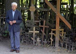 An elderly pilgrim stands by Orthodox crosses at the Holy Hill of Grabarka August 18, 2011/Peter Andrews