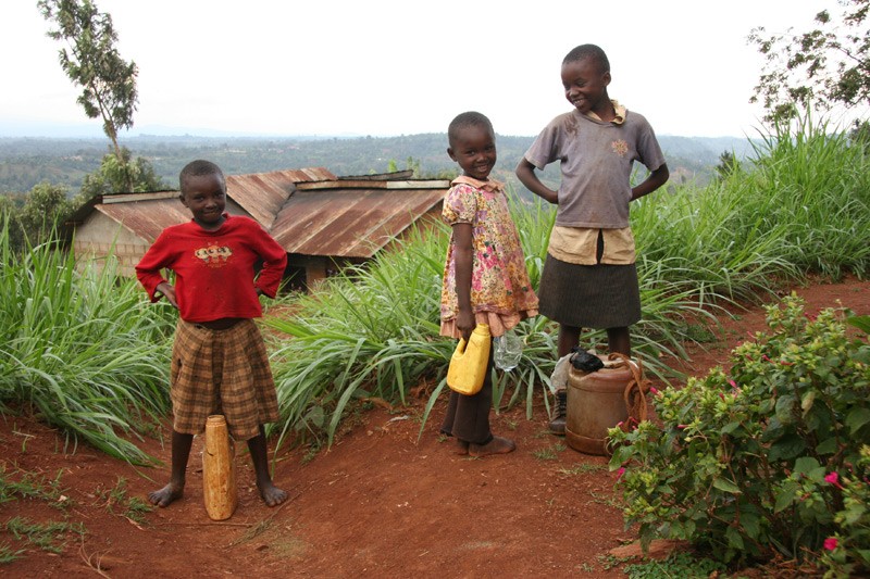 Fetching water. Children fetching water at the churchyard of St. Anthony's.  Photo: Denis Makhanko 