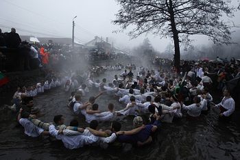 Загрузить увеличенное изображение. 950 x 634 px. Размер файла 161718 b.  Bulgarian men dance in the icy waters. Photo:Reuters.