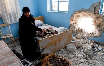 Sr Verona, head of the Saydnaya convent, in a room in the convent that was damaged in a recent mortar attack. Photograph: Bassem Tellawi/AP