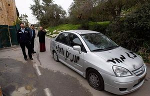 "Price tag" and "Greeks out" scrawled on a car outside of Jerusalem's Monastery of the Cross