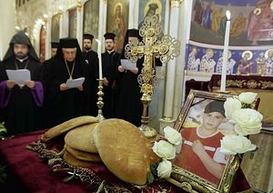 Greek Orthodox priests in Damascus pray during a Mass in January for a Christian boy who was killed in the fighting in the central Syrian city of Homs. (Joseph Eid / AFP/Getty Images / January 9, 2012) 