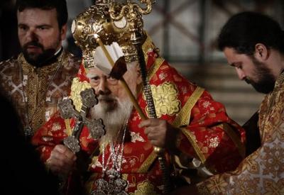 In this Sunday, April, 24, 2011 file photo Bulgarian Patriarch Maxim is helped as he blesses people around the golden-domed Alexander Nevski cathedral after an Easter Mass, in the Bulgarian capital Sofia. Patriarch Maxim of Bulgaria, the spiritual leader of the Balkan country's Orthodox Christians, has died. He was 98. The patriarch died early Tuesday Nov. 6, 2012, at a Sofia hospital, the Holy Synod said in a statement. (AP Photo/Valentina Petrova, File)