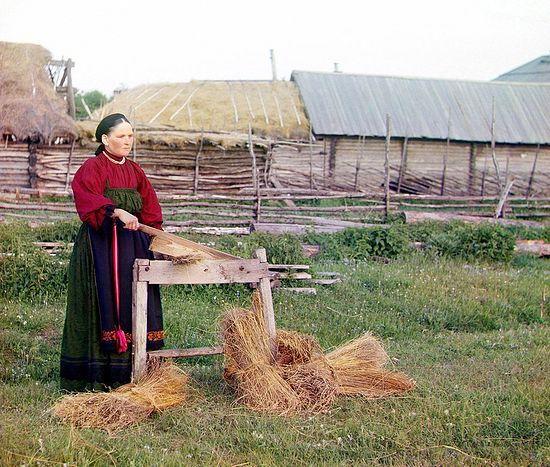A peasant woman pressing/softening linen. Perm Province. Photo by S. M. Prokudin-Gorsky. 1910