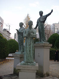 Статуя монаха ордена иезуитов Франциска Ксавье с учениками Ядзиро и Бернандо в парке напротив мемориального Собора в Кагосима
