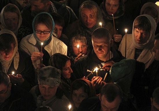 Russian Christian Orthodox worshippers light candles as they wait for a holy Easter service at the Church of St. Peter and Paul in Karlovy Vary May 5, 2013. The spa town of Karlovy Vary has a large number of Russian residents and is also a popular tourist destination for visitors from Russia. Photo: Reuters