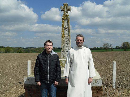 Author Dimitry Lapa with Archpriest Andrew Phillips at the cross of St. Edmund in Hoxne.