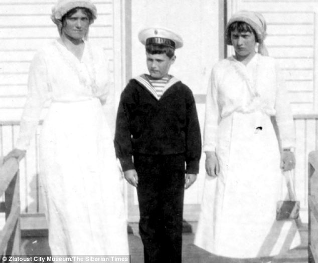 In this 1914 picture, four years before their execution, Nicholas's heir Alexei is seen with sisters Olga, left, and Tatiana, right.