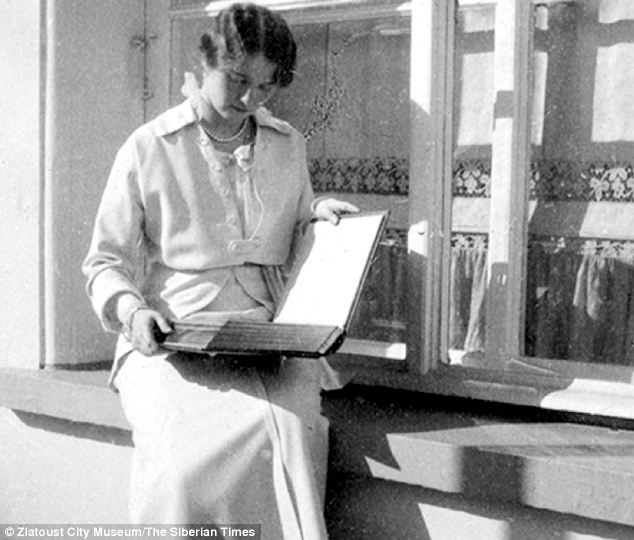 Grand Duchess Olga is seen looking through a family album.