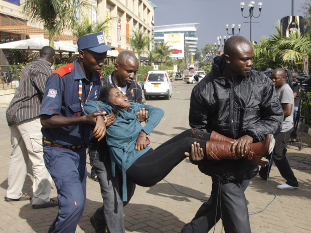 AP Photo/Khalil Senosi. A security officer helps a wounded woman outside the Westgate Mall in Nairobi, Kenya Saturday, Sept. 21, 2013, after gunmen threw grenades and opened fire during an attack that killed almost 70 people.
