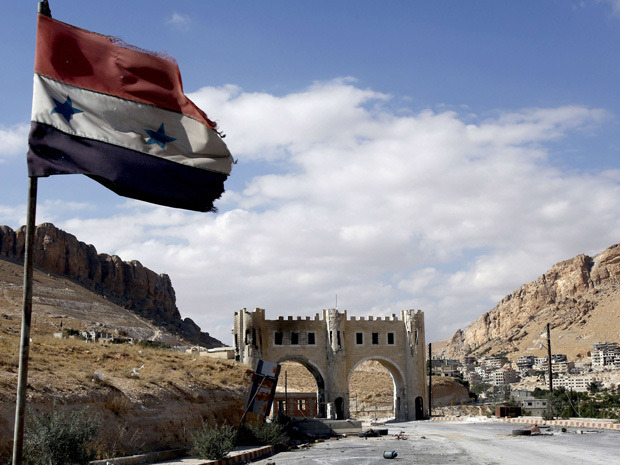 ANWAR AMRO/AFP/Getty Images. A picture taken on September 18, 2013 shows the Syrian flag flying on the side of a road leading to Syria's ancient Christian town of Maalula, as fighting continues between government forces and rebel fighters. The town lies around 55 kilometres from Damascus and is strategically important for the rebels, who are trying to tighten their grip on Damascus.