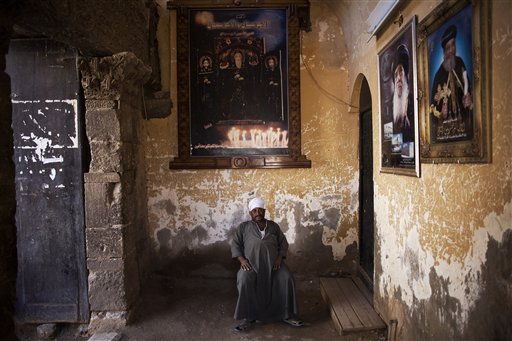 An Egyptian man guards the gate of a church at the Red Monastery in Sohag