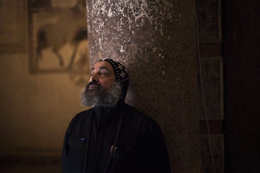 Father Antonius stands in the Anba Bishay Church while looking at the paintings the Anba Bishay Church at the Red Monastery