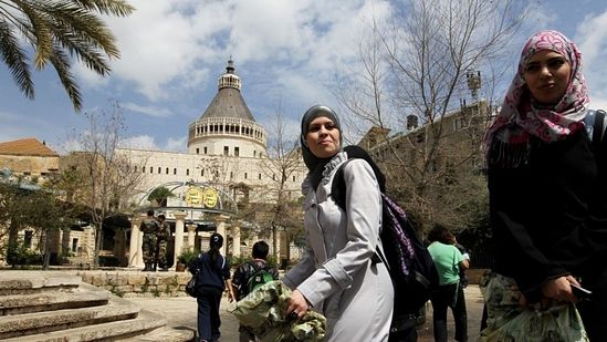 Muslim women pass by the Basilica of the Annunciation in Nazareth, March 2011. Photo: Natti Shohat/Flash90