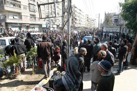 Syrian civilians are seen in Babila town, southeast Damascus February 17, 2014, after a local ceasefire agreement was reached between the opposition and regime forces. REUTERS/Khaled al-Hariri