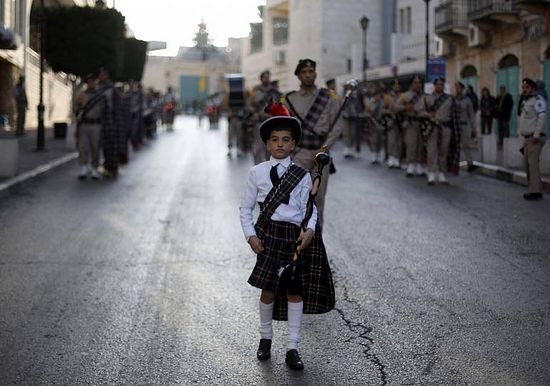 A Palestinian boy takes part in the Eastern Orthodox Christmas procession outside the Church of the Nativity in the West Bank town of Bethlehem,Palestine