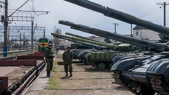 Ukrainian armored vehicles are prepared for loading onto a train at a railway station near Simferopol, Crimea, Saturday. (THE ASSOCIATED PRESS)