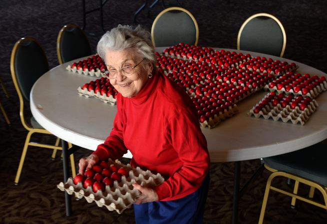 Theano Peros, 89, picked out a dozen eggs to take home after she and the Women of the Greek Orthodox Cathedral dyed more than 1,200 of them to be sold or handed out to worshipers on Easter Sunday. (Karl Gehring, The Denver Post)