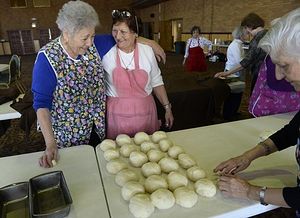 From left, Dena Kitsos, Katina Kapantas and Rose Evridis — members of Philoptochos, meaning friends of the poor — prepare 150 loaves of Easter bread at Assumption of the Theotokos Greek Orthodox Metropolis Cathedral. (Kathryn Scott Osler, The Denver Post)