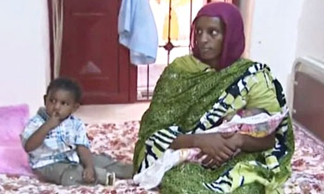 Meriam Ibrahim holds her newborn daughter Maya alongside her 20-month-old son Martin in her Sudanese prison cell.