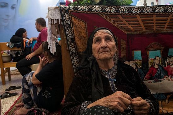Farida Pols Matte, 80, in Ankawa, Iraq, with her family and other Iraqi Christian refugees. They are among the hundreds of thousands of people displaced by the Islamic State in Iraq and Syria. Photo: Lynsey Addario/The New York Times