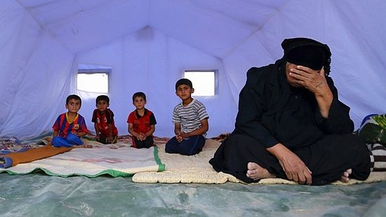 Беженцы в палатке на окраине Эрбиля. Июнь 2014 г., Reuters