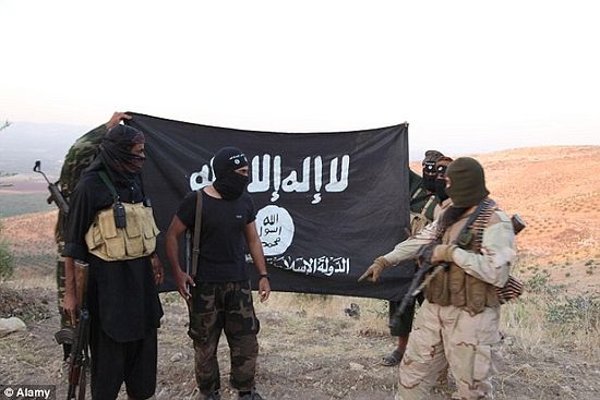 ISIS fighters holding the Al-Qaeda flag with 'Islamic State of Iraq and the Levant' written on it. A single militant from the group is believed to be alone responsbile for gunning down 150 women 
