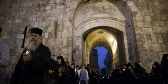 Christian Orthodox nuns hold candles and flowers as they walk along the Via Dolorosa in the old city of Jerusalem. (Photo: Yonatan Snidel/ Flash90)