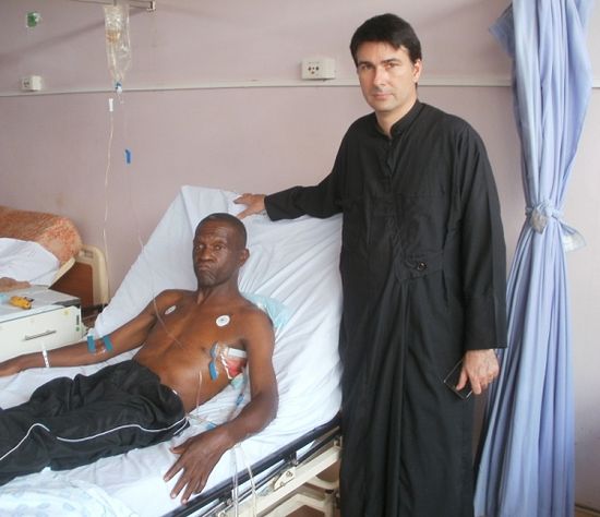 Fr Elias visiting Artmius Mangena in hospital after he was shot by robbers