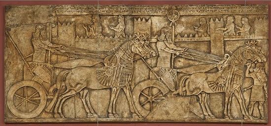 A relief from Nimrud depicting a palace with two chariots standing near it. A casting. Length: 215 cm (7.05 feet). The original is of the 9th century B.C., the British Museum, London. Photo by the Pushkin State Museum.