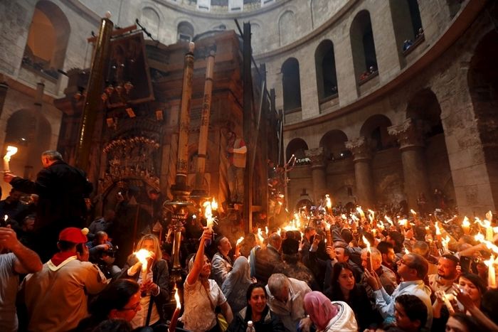 Reuters / Worshippers hold candles as they take part in the Christian Orthodox Holy Fire ceremony at the Church of the Holy Sepulchre.