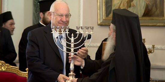 The Greek Patriarch presents Israeli President with silver menorah on Tuesday, March 14. 