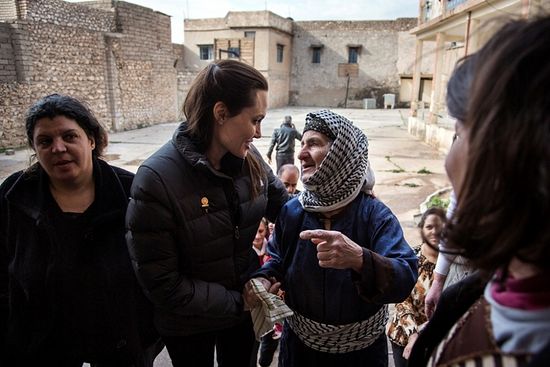 United Nations High Commissioner for Refugees Special Envoy Angelina Jolie (2nd L) meets displaced Iraqis who are members of the minority Christian community, living in an abandoned school in Al Qosh, northern Iraq, January 26, 2015. 