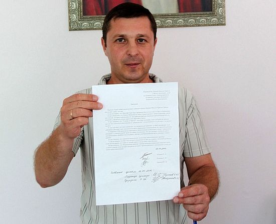 Oleg Kozhin holds his letter of resignation from the Mormon organization (the Church of Jesus Christ of Latter-day Saints)