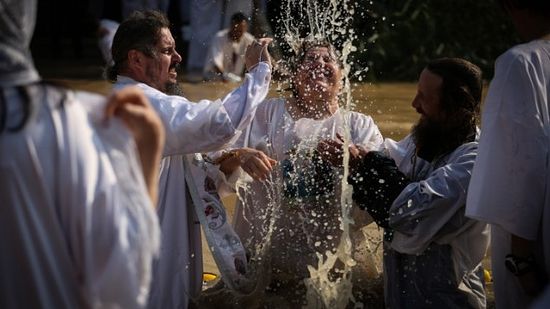 Orthodox Christian pilgrims take a dip in the Jordan river as part of a traditional Epiphany baptism ceremony at the site of Qasr al Yahud on January 18, 2015. (Hadas Parush/Flash90)