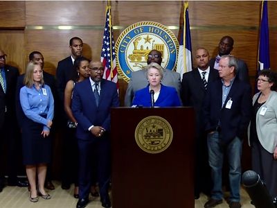 Houston Mayor Annise Parker (at podium) announces the withdrawal of subpoenas for the sermons of five local pastors at a press conference on Wednesday October 30, 2014.