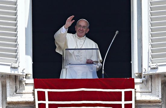 Pope Francis waves as he leads the Angelus prayer from the window of the Apostolic palace in Saint Peter's Square at the Vatican August 9, 2015. 