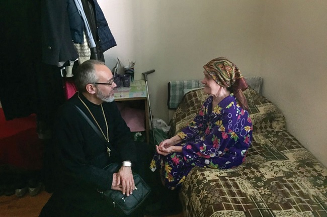 A refugee speaks with Bishop Daniel.
