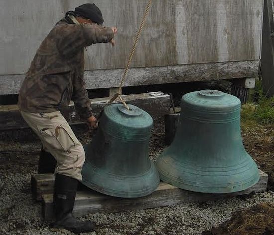 Volunteer Valery Kolosov helps to steady a large Belkofski bell/ Credit: Fr. Andrei Tepper.