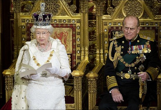 Queen Elizabeth II addressing both Houses of Parliament, with her consort Prince Philip looking on.